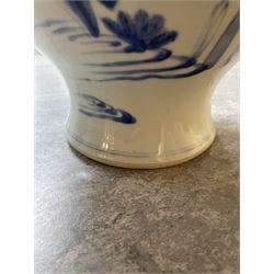Pair of Chinese Kangxi blue and white porcelain vases, each of baluster form, painted with an outdoor scene containing figures seated upon the ground reading scrolls and holding fans, willow and bamboo tress, rock work and water, H27cm