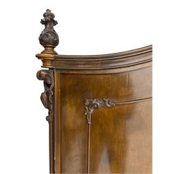 Early 20th century Italian walnut armoire wardrobe, the pierced and scrolling pediment carved with acanthus leaf detail, flanked by two scrolling cartouche with matching corbels below, the two panelled doors with applied carved rinceaux slips, with a central spiral turned upright, enclosing single shelf and hooks, raised on scroll feet
