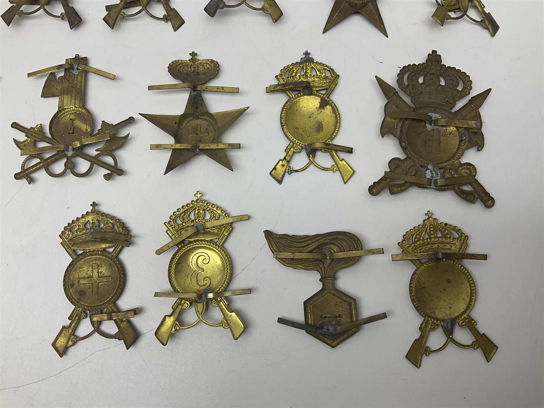 Over thirty British and Continental military metal badges; together with quantity of shoulder titles, collar dogs, rank pips, uniform buttons etc