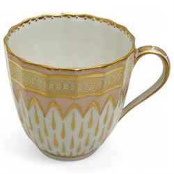 Derby coffee cup and large saucer, pattern 119, c.1795, the apricot ground decorated with gilt teardrop motifs and intricate Vandyke boarder, with crown, D mark and crossed batons in puce to base, decorator's mark no. 2 for Joseph Stables