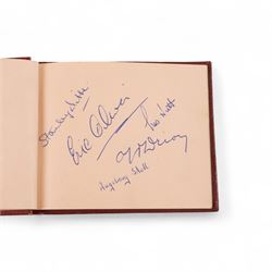 1950s autograph book, containing mostly motorcycle racing signatures, including four-time World Sidecar Champion Eric Oliver, 1952 Sidecar World Champion Cyril Smith and1955 Junior TT Champion Jack Bailey, in red leather case with gilt lettering 
