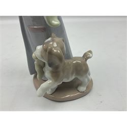 Lladro figure, Dear Santa, modelled as young boy in dressing gown and Santa hat with dog, sculpted by Antonio Ramos, with original box, no 6166, year issued 1995, year retired 1999, H21cm