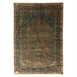 Antique Persian rug, with central tree of life design on a camel field, enclosed by dark b...