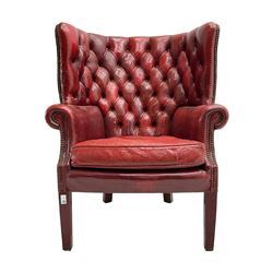 Georgian design barrel wingback armchair, upholstered in buttoned leather with studwork 