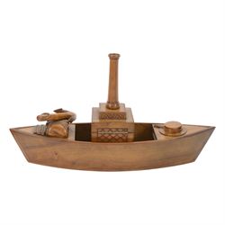 Novelty desk inkwell formed as a boat, with central chimney opening to reveal a metal inkwell with two pens formed as oars, together with another inkwell in the from of a bull dog 