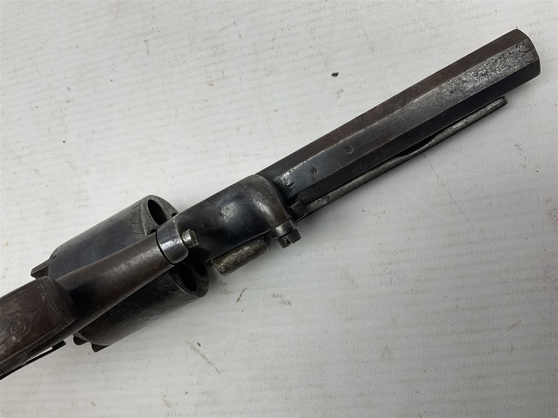 Mid-19th century Smith London .36 cal. transitional five-shot percussion revolver, the 12cm rifled octagonal barrel with side loading lever, side safety, some engraved decoration and chequered two-piece grip L28cm overall