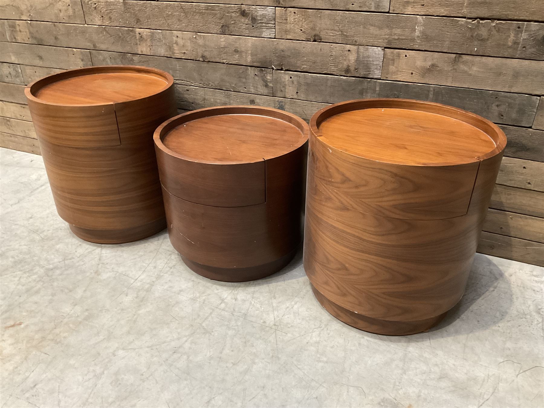 Three walnut circular barrel shaped lamp tables, fitted with single drawer (lower table D53cm, H49cm)