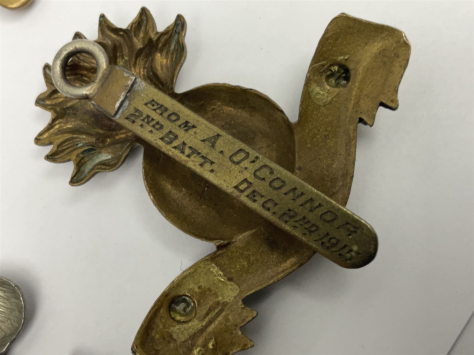 Fourteen cap badges of Irish interest including Royal Dublin Fusiliers inscribed to the slider 'From A. O'Connor 2nd Batt. Dec.2nd 1915', Connaught Rangers, South irish Horse Yeomanry, Inniskilling Fusiliers, Royal Irish Regiment etc; and seven Welsh badges including South Wales Borderers, Welsh Guards, 3rd Bn. Monmouthshire Regt. etc (21)