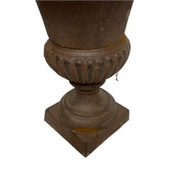 Two pairs of cast iron Campana-shaped garden urns, egg and dart moulded rim over gadrooned underbelly, on circular foot and square base 