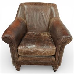 Tetrad - late 20th century leather armchair, upholstered in brown leather with a gently curved back and rolled arms, loose seat cushion over a padded base, raised on turned wooden feet