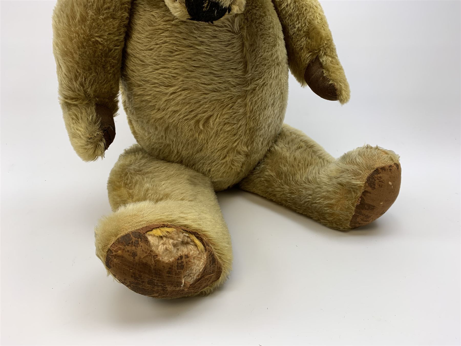 Very large Irish Tara bear c1950s with plush covered body, swivel jointed head with glass eyes and vertically stitched nose and mouth, jointed limbs with rexine pads and growler mechanism H37