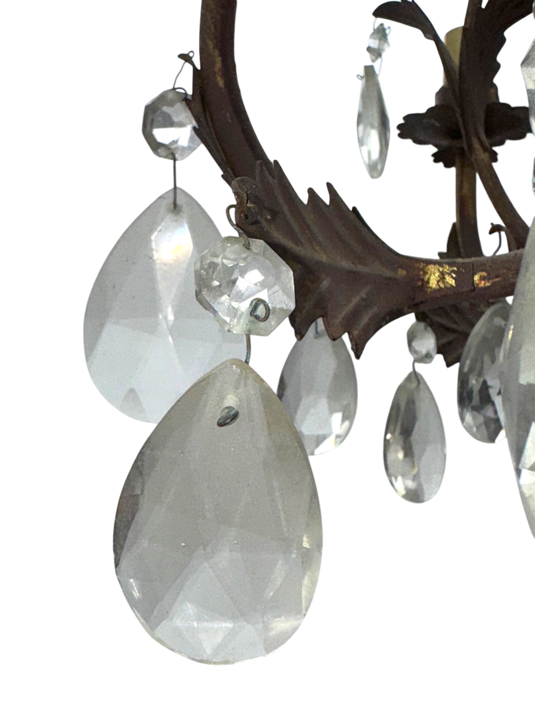 20th century distressed gilt tole chandelier, with six curved leaf clasped scrolling arms and frame, hung with lustre drops, approximately H50cm