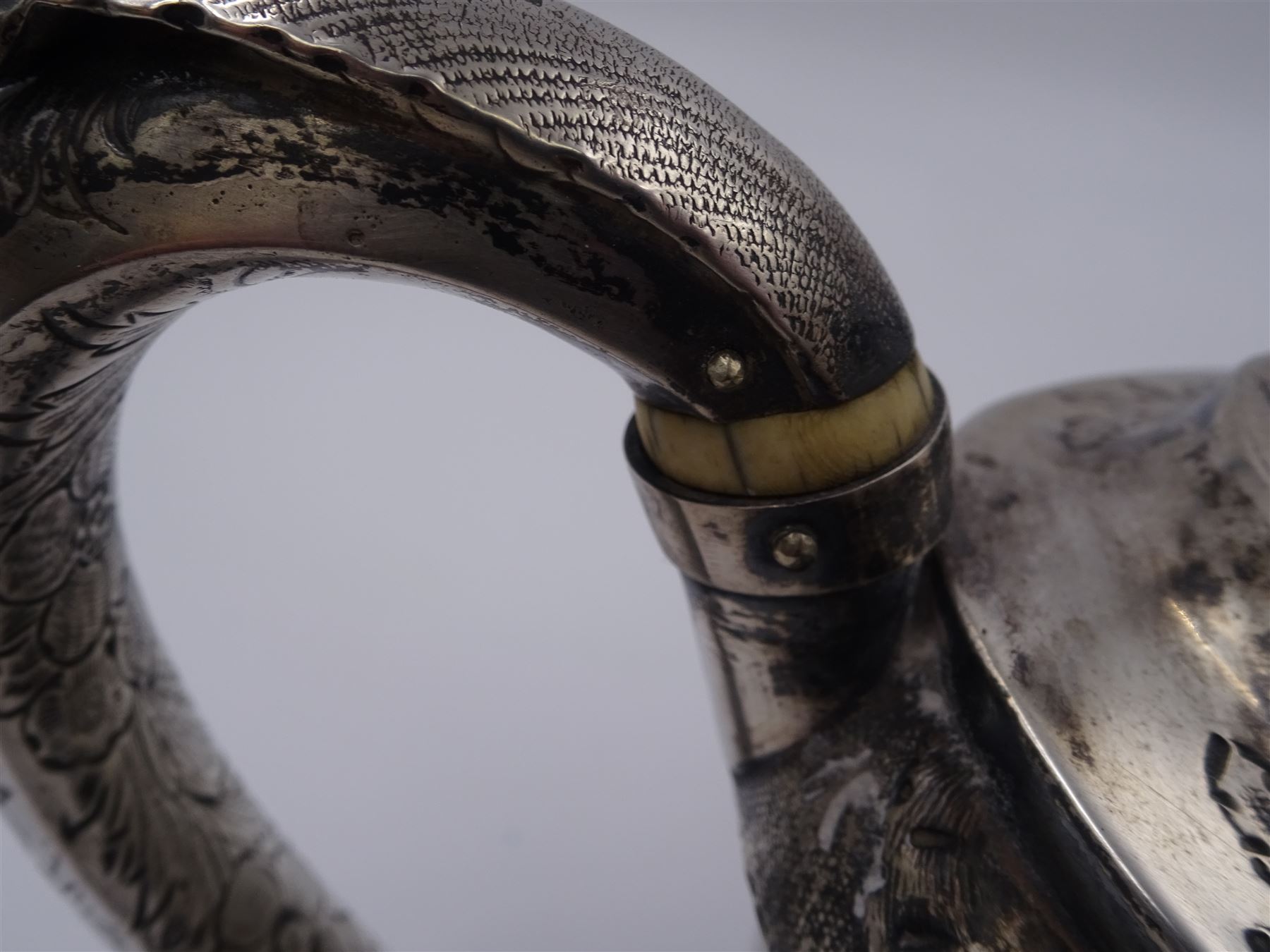 George III silver teapot, of oval form, with embossed foliate, floral and scroll decoration and engraved central cartouche, with acanthus capped C handle with ivory insulators, hallmarked John Emes, London 1807 This item has been registered for sale under Section 10 of the APHA Ivory Act
