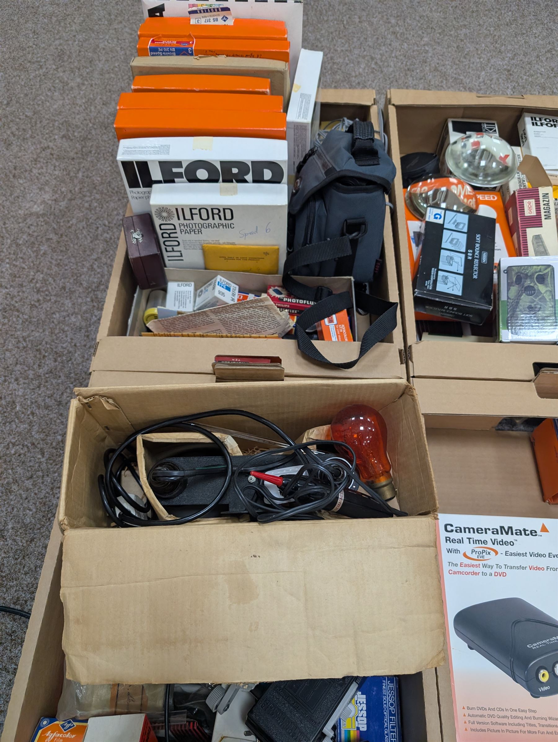 Large collection of photography equipment, including two video cameras JVC and a Panasonic 3CCD, tripods, filters, photograph paper, developing equipment, Dalite projector screen, etc, some boxed some empty boxes, and a Midgard Pocket Microscope