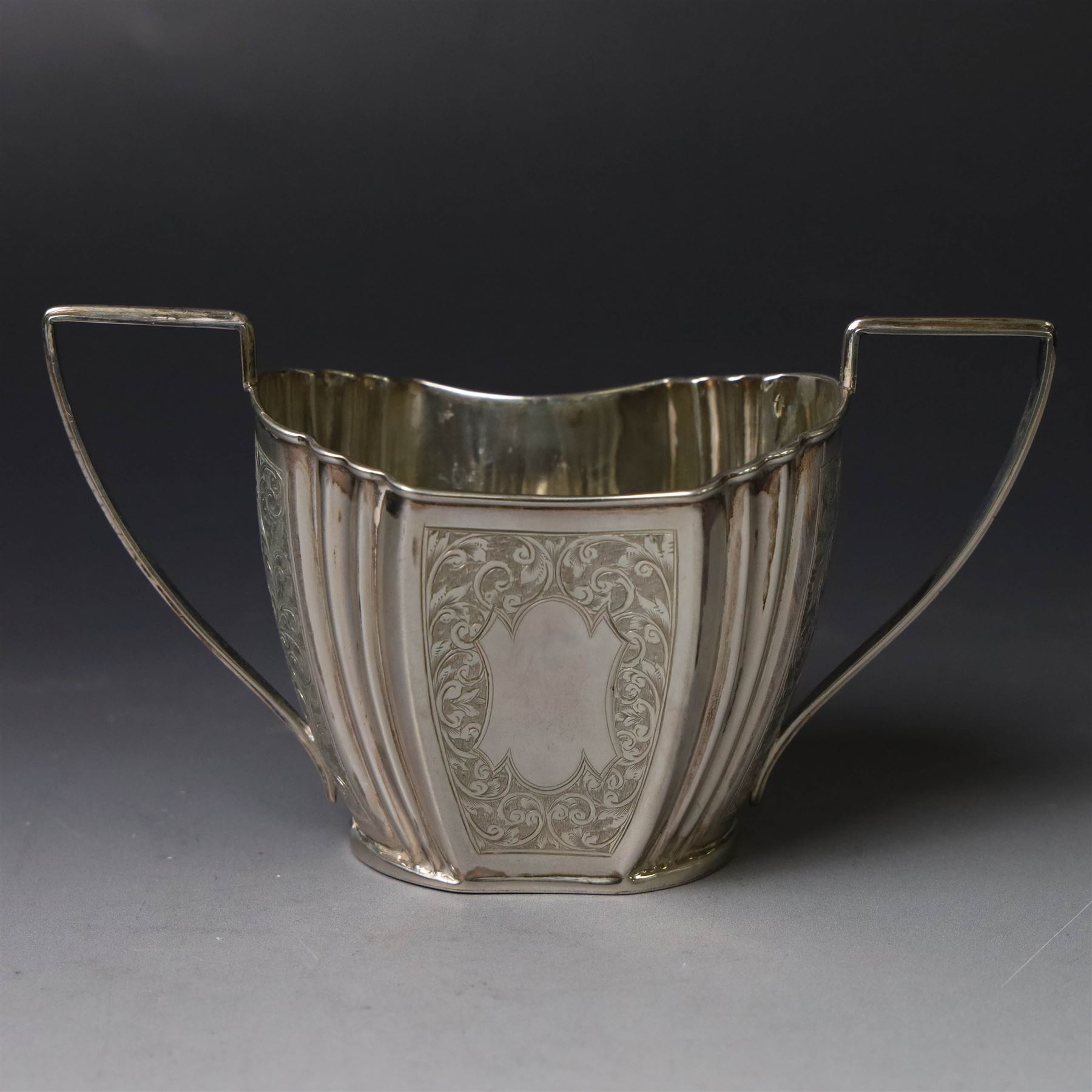 Late Victorian silver twin handled open sucrier and milk jug, of fluted form with panels of engraved foliate decoration, hallmarked D & M Davis, London 1896