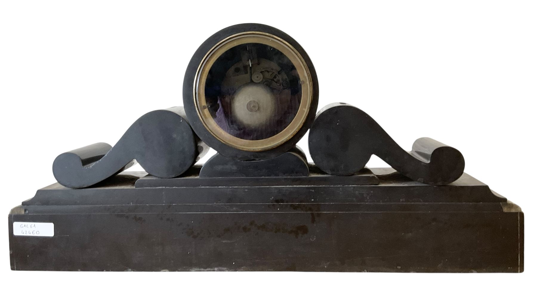 French- late 19th century 8-day Belgium slate and marble mantle clock, drum movement with volutes and conforming scroll side pieces, on a stepped plinth with incised decoration to the front, two-piece enamel dial with a visible Brocot deadbeat escapement, spade hands and Roman numerals, twin train, countwheel striking movement, sounding the hours and half-hours on a bell. With pendulum and key. 