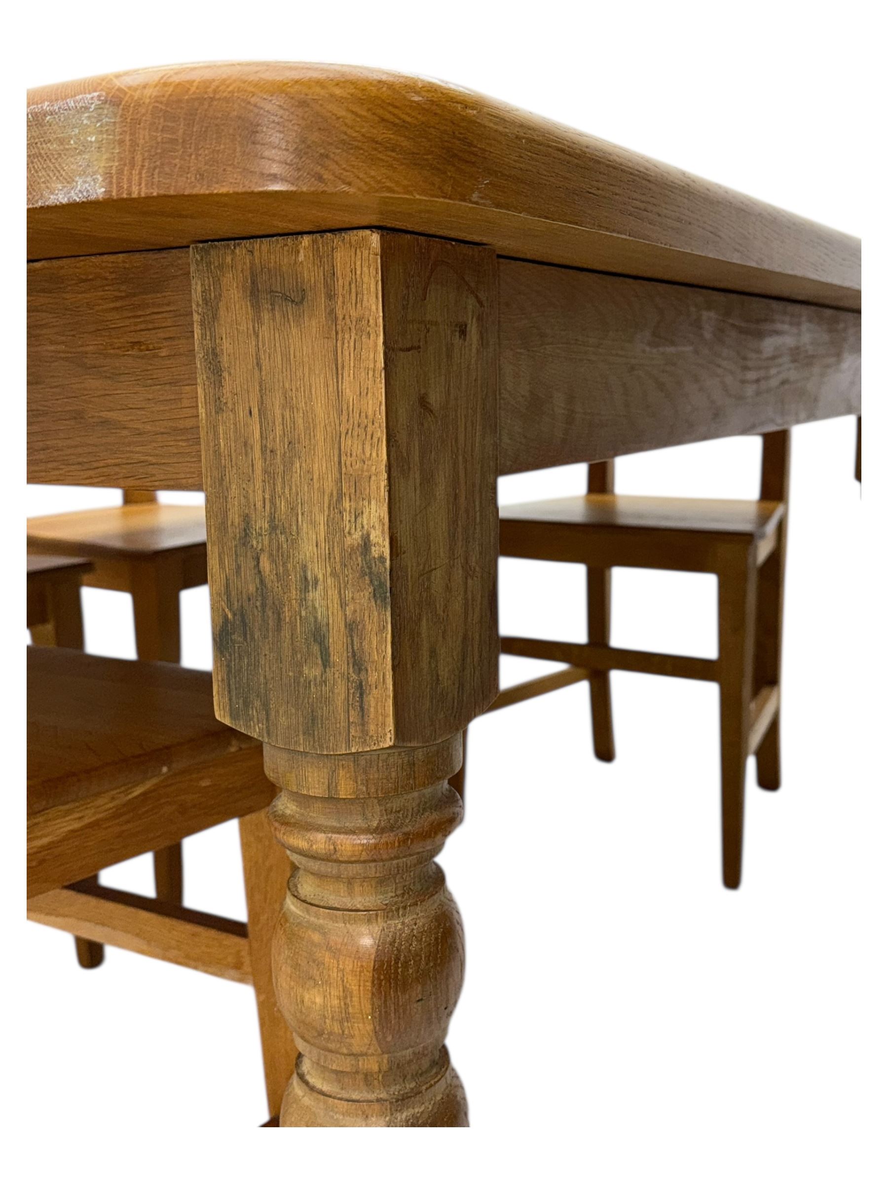 Contemporary light oak farmhouse dining table, and four oak ladder back dining chairs, rectangular top with rounded corners, raised on four turned baluster legs in natural lacquered finish, chairs with three horizontal slats beneath a shaped top rail, solid seat and square section legs united by stretchers