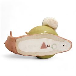 Royal Dux figural posey holder, modelled as a boy with baskets riding a snail, H16.5cm