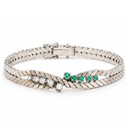 14ct white gold diamond and emerald crossover bracelet, the central section set with five ...
