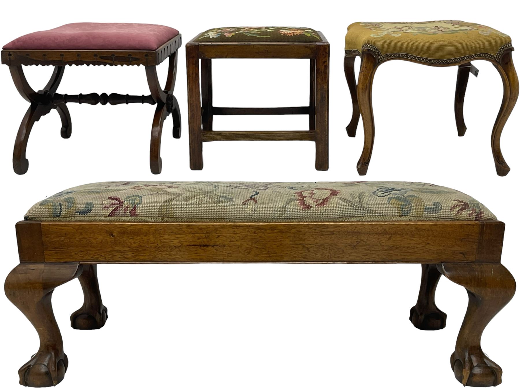 20th century mahogany rectangular footstool, needlework upholstered drop-in seat, on ball and claw carved feet (W81cm, D35cm, H34cm); 19th century elm stool, needlework upholstered drop-in seat, on square moulded supports united by plain stretchers (W45cm); 19th century walnut stool, shaped top upholstered in needlework, on cabriole supports (W50cm); 19th century rosewood stool, upholstered drop-in seat, on curved x-framed supports united by turned stretcher (W47cm)