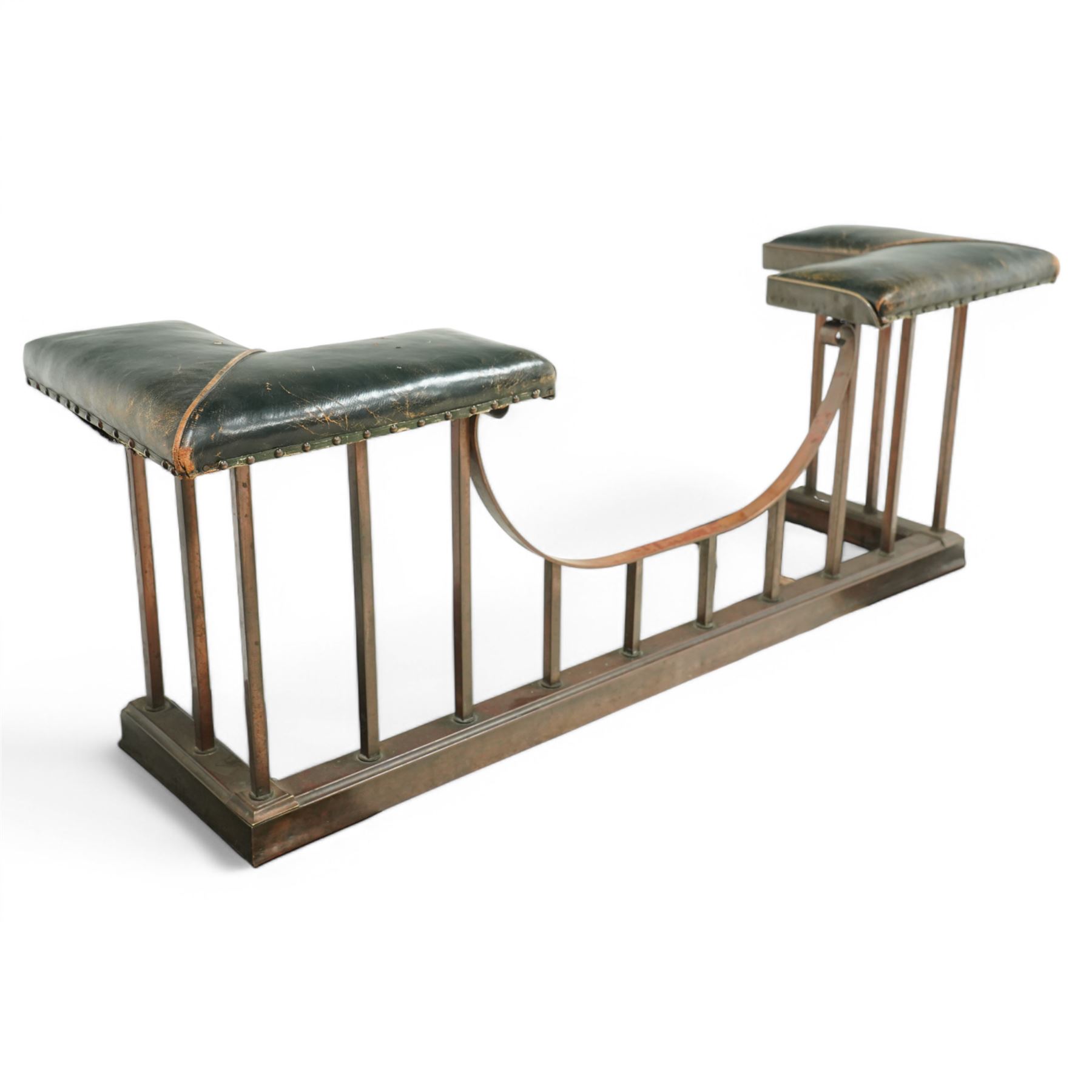 Early 20th century brass and buttoned green leather club fender with plain uprights 