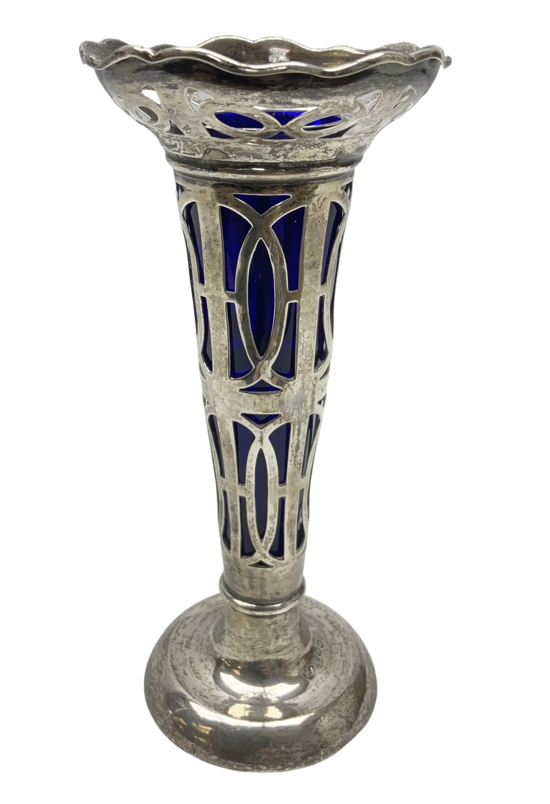 20th century silver specimen vase, of pierced trumpet form with flared rim, filled base, and blue glass liner, hallmarked Birmingham 