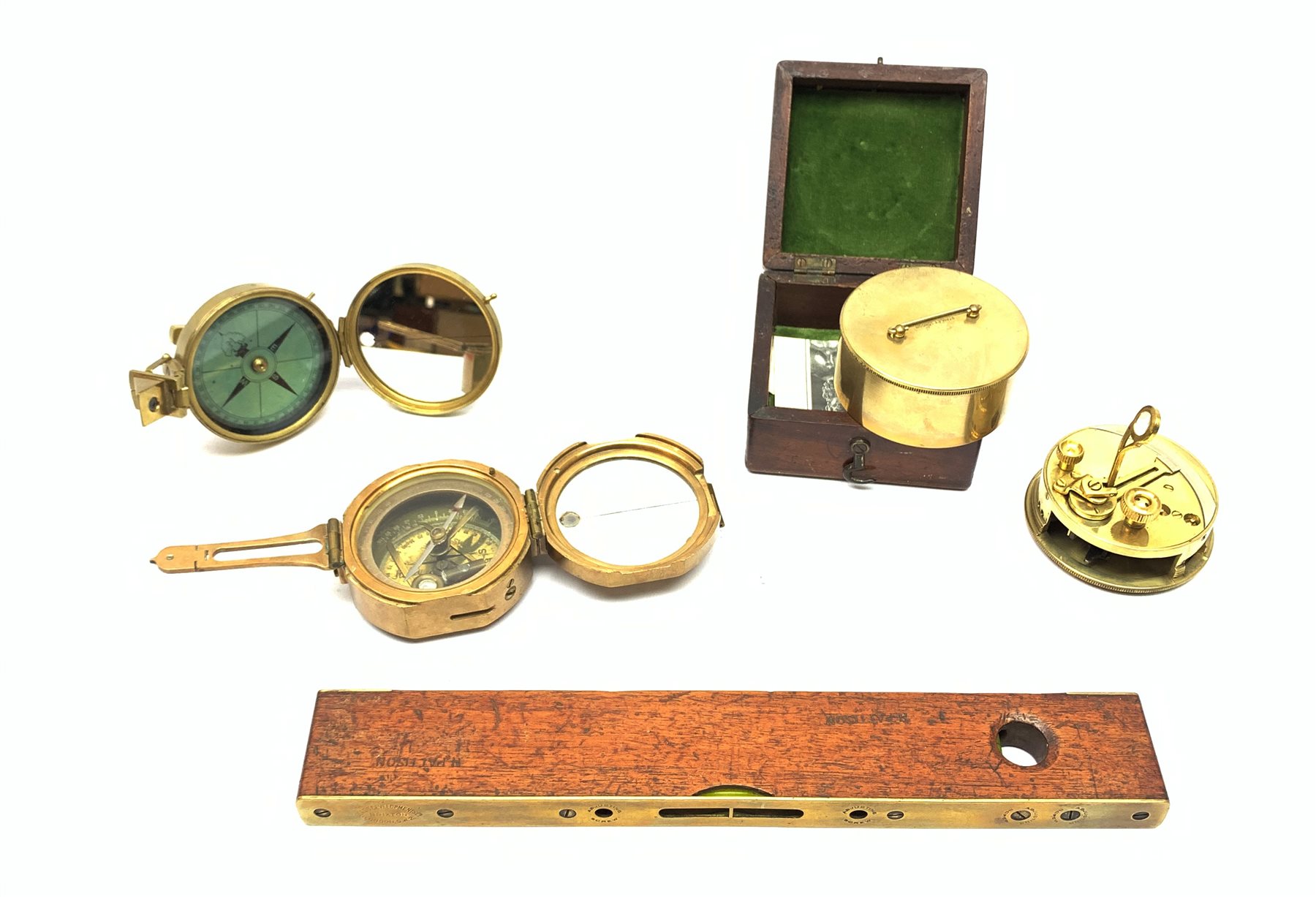 Brass Natural Sine type compass with spirit levels to the dial, bears name of Stanley, D8cm, in earlier mahogany box; brass pocket sextant of drum shaped form, the screw top marked Stanley London; small brass cased compass with pedestal tripod base; and Glass Developments Ltd. hahogany and brass spirit level L31cm (4)