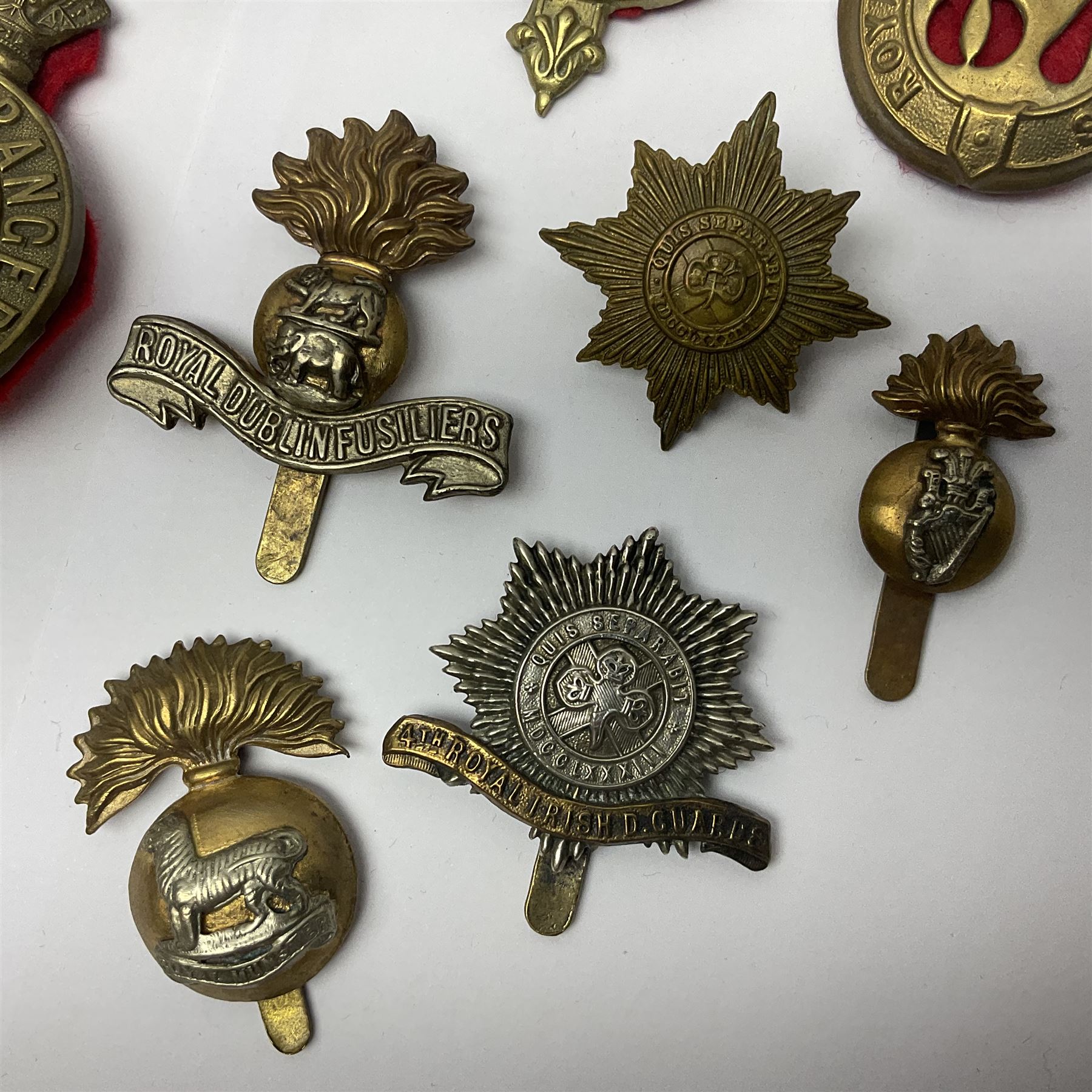 Fifteen cap badges of Irish interest including 4th Royal Irish Dragoon Guards, Connaught Rangers, Royal Irish, Munster and Dublin Fusiliers, 5th Lancers, Inniskilling Regt.,Leinster Regt., Irish Guards etc (15)