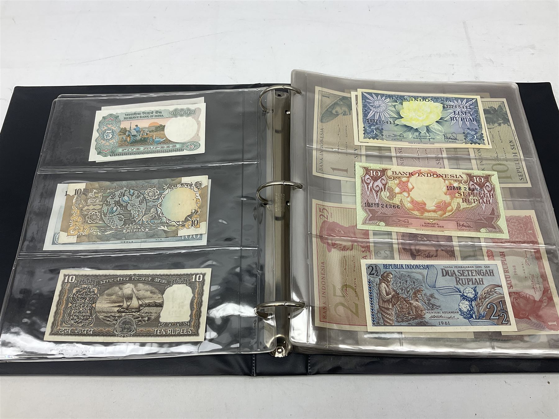 World banknotes, including Queen Elizabeth II The States of Jersey one pound 'DB202703', five pounds 'BB527762' and ten pounds 'AB651481', reserve bank of New Zealand two dollars '1L3 741894', King George V Straits Settlements one dollar 1st January 1935 'F/83 28924', various Bank of England notes etc, housed in two ring binder albums