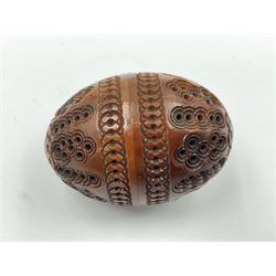 Three 19th century coquilla nut pomanders or flea catchers, two of egg shaped form and the third of barrel from with carved and pierced decoration and screw threaded join, largest H8cm