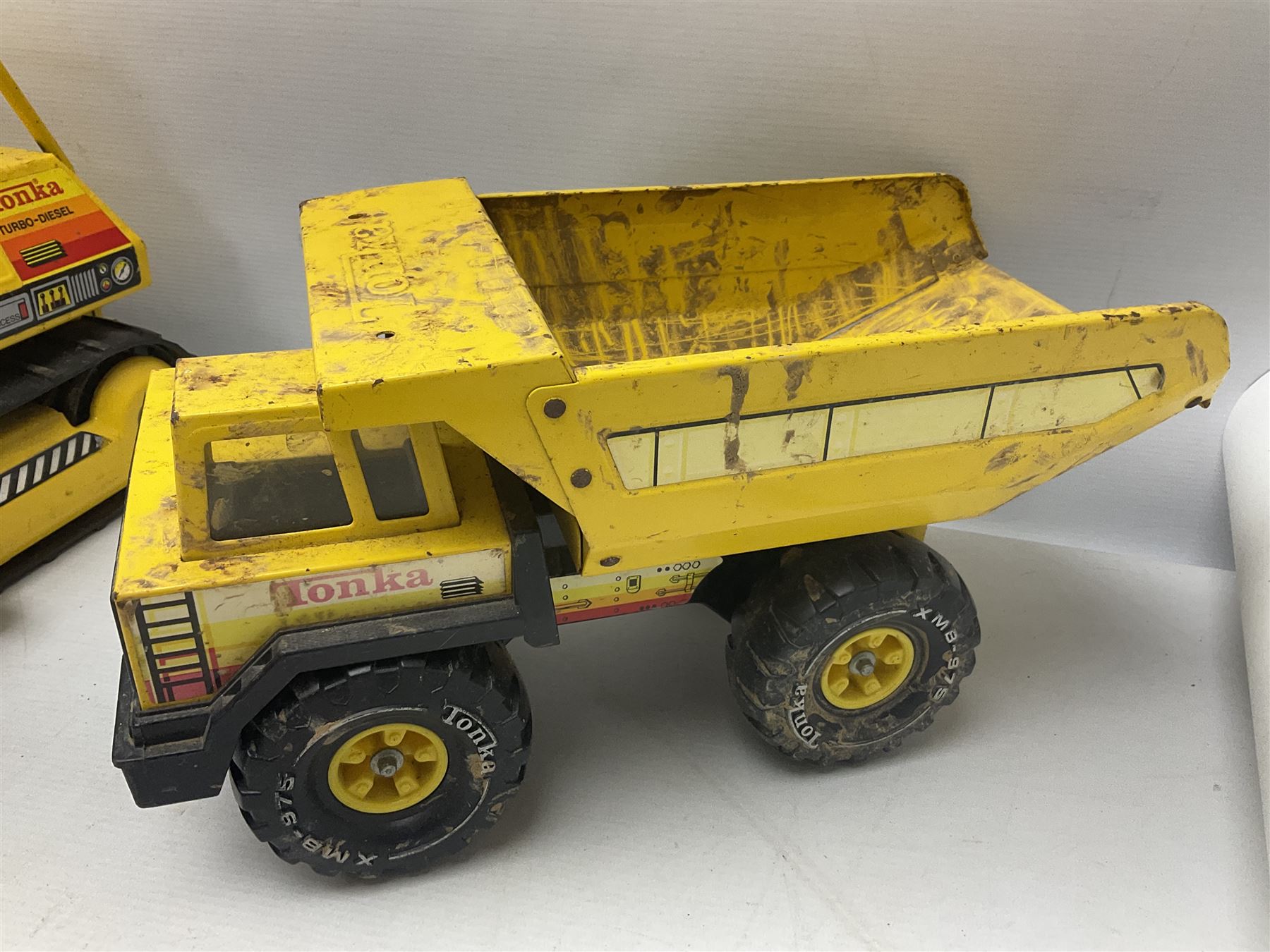 Tonka - five large scale pressed steel vehicles comprising Cement Mixer, Mobile Crane, Bulldozer and two Dumper Trucks (5)