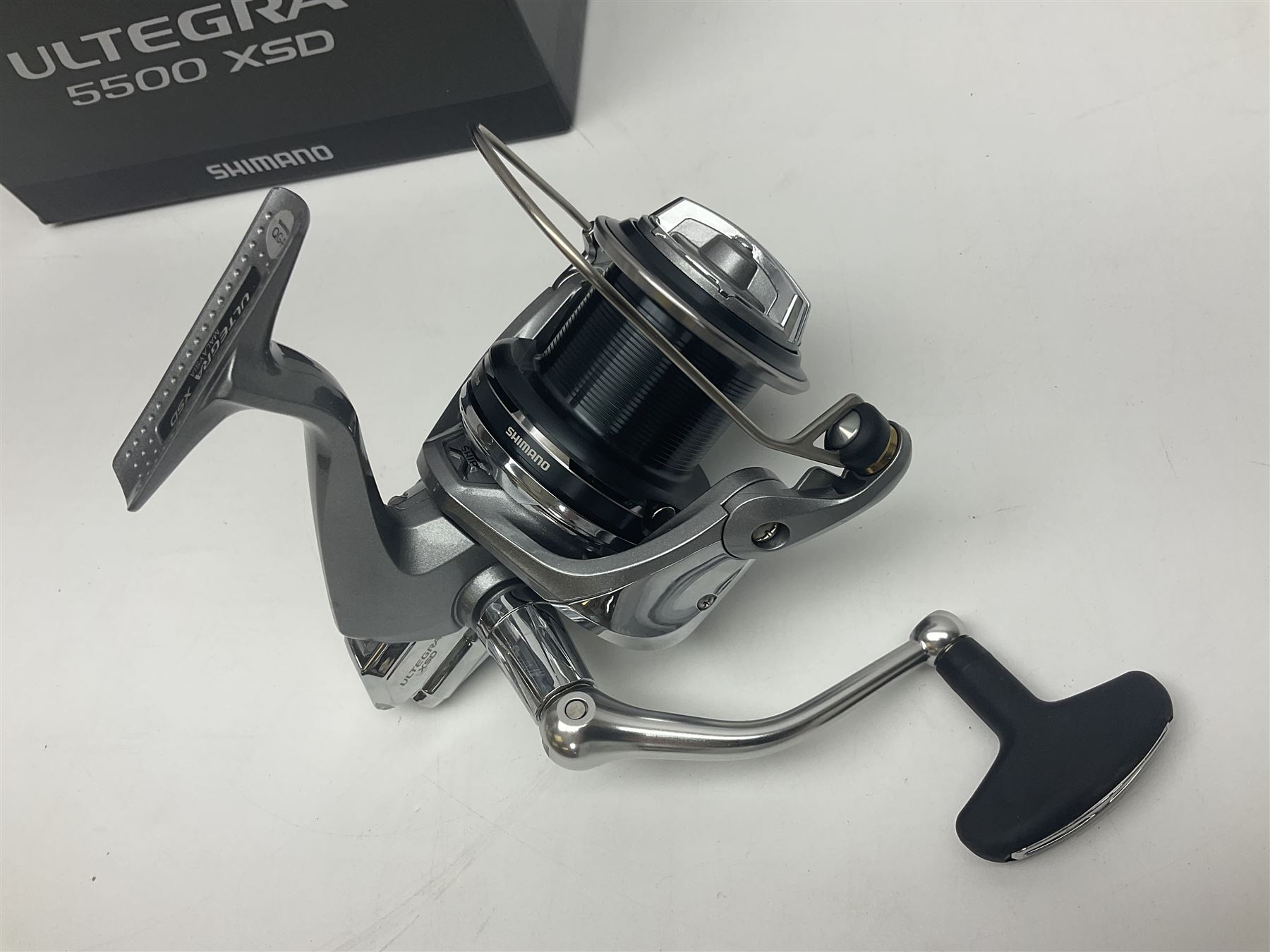 Four fixed spool reels, all in original boxes, comprising Shimano Ultegra 5500 XSD, with spare spool, Mitchell Autosurf 700, with spare spool, Shimano Sedona 600 FB with spare spool and D.A.M Quick 5001
