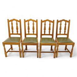 Beaverman - set of four oak dining chairs, shaped cresting rail over two shaped vertical rails, green leather upholstered drop-in seats, on octagonal supports united by plain stretchers, each carved with beaver signature, by Colin Almack, Sutton-under-Whitestone Cliffe, Thirsk