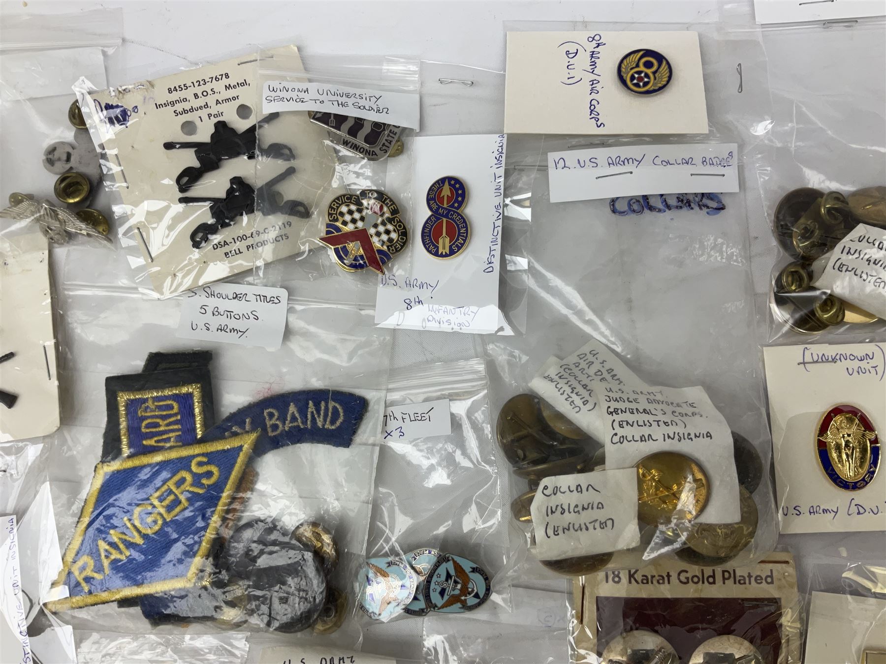 American patches and badges, including para wings, USS Constellation, Strategic Air Command, U.S. military academy, health service regt, Navy Seals, Air Defence Command, Seventh Fleet, various collar badges etc