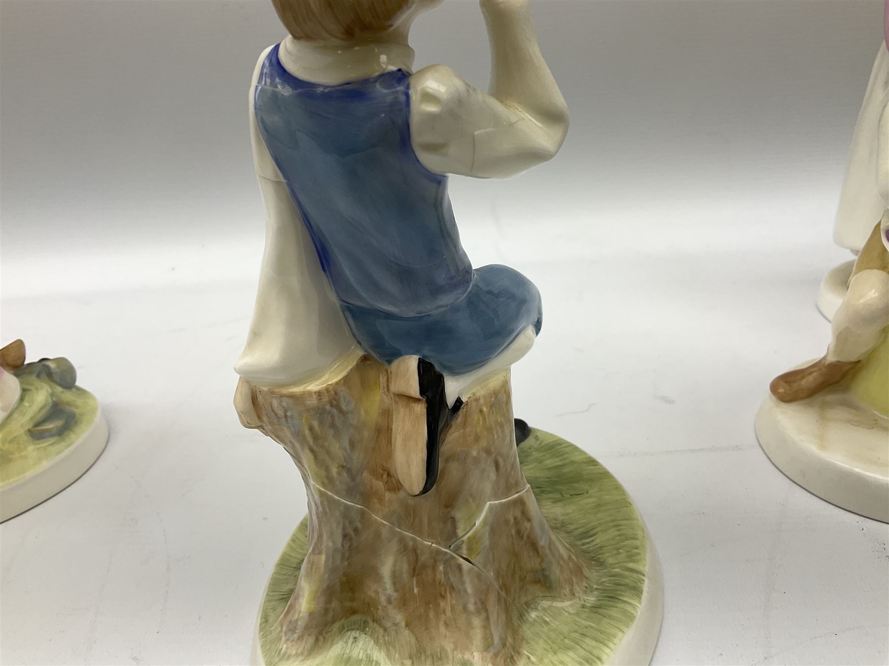 Seven Royal Doulton figures from the Nursery Rhymes Collection comprising, Tom Tom, the piper's son HN3032, Little Jack Horner HN3034, Wee Willie Winkie HN3031, Polly, put the kettle on HN3021, Little Bo-peep HN3030, Little Boy Blue HN3035, Little Miss Muffet HN2727, together with two Royal Doulton Mary had a little lamb figures HN2048 and COPR1948, all with printed marks beneath  