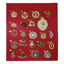 Twenty-two glengarry and cap badges including Argyll & Sutherland, Devonshire, Essex, Hampshire, Royal Berkshire, Northamptonshire, Long Range Desert Group, Royal Corps of Signals, Norfolk, Dorsetshire, East Lancashire etc; mounted on a board for display