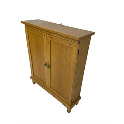 Andrena - light oak side cabinet, two panelled doors enclosing two shelves flanked by two CD racks