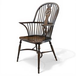 Late 19th century elm and beech high back Windsor armchair, the arched hoop back centred by a pierced wheel splat above a heart shaped lower piercing, with turned spindles and shaped arm rail, saddle seat, raised on turned legs united by a crinoline stretcher