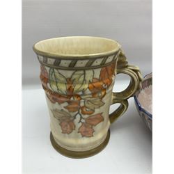 Charlotte Rhead for Crown Ducal ceramics, comprising coffin shaped vase depicting a woman in 1920s dress, a vase with handle, decorated with autumn leaves and a bowl, decorated with flowers and berries, with printed and signed marks beneath, coffin vase H24cm
