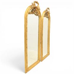 Louis XVI style giltwood pair of wall mirrors, arched frames with moulded borders, surmounted by ribbon tied floral crestings and trailing husk swags, enclosing bevelled mirror plates