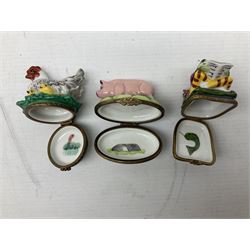 Group of Limoges trinket boxes, to include a number of novelty examples, including examples modelled as Noah's ark, shotgun case containing shotguns, picnic basket containing food, toad reading book seated upon a lily pad, etc., (9)