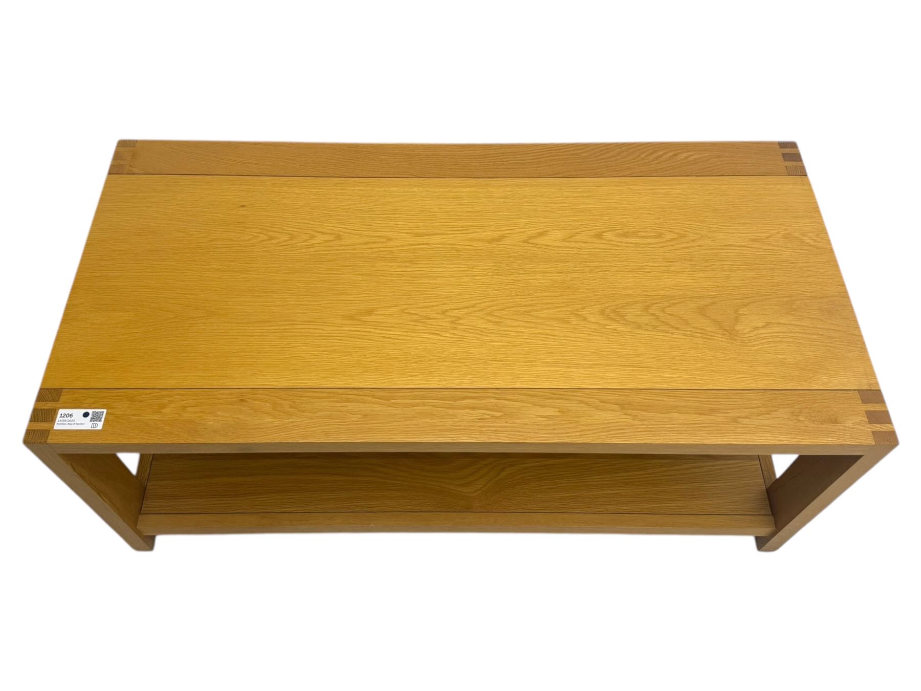 Light oak rectangular coffee table, with exposed finger joints to the corners, raised above a full-length undertier on straight supports