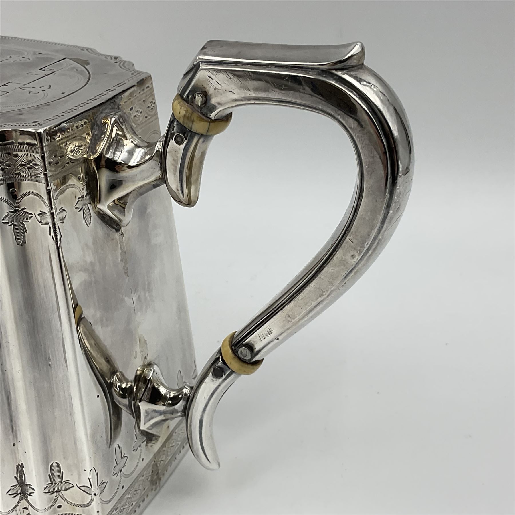 Victorian three-piece silver tea service, comprising teapot, twin handled open sucrier and milk jug, of oval form with shaped rim and C handles, each engraved with crests and bands of strapwork decoration, the milk jug and sucrier with gilt interiors, hallmarked Josiah Williams & Co, Exeter 1881, the teapot with ivory insulators and finial, all contained with a tooled leather, blue silk and velvet lined fitted case, retailed by West & Sun, Dublin 
This item has been registered for sale under Section 10 of the APHA Ivory Act