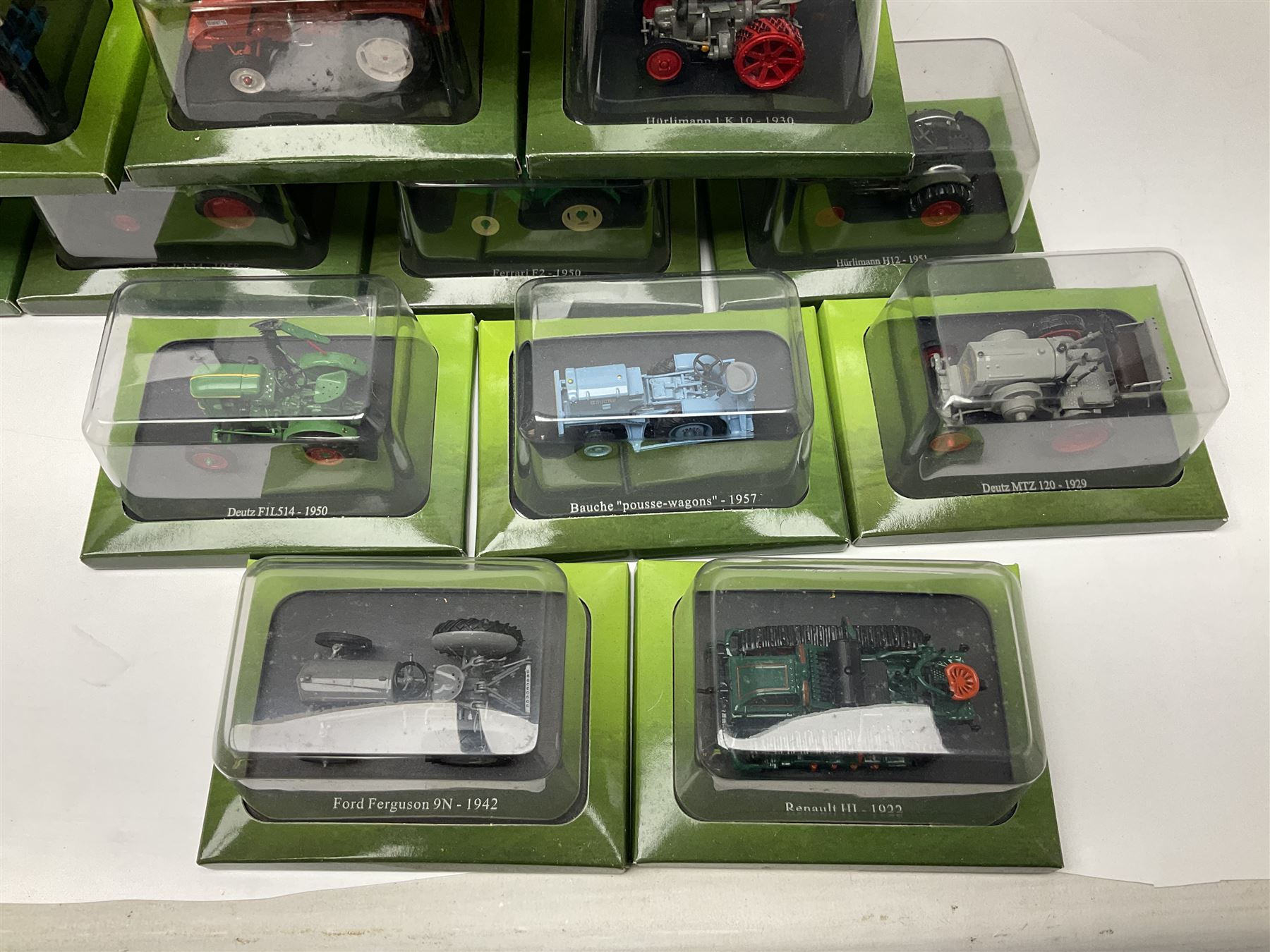 Eighteen issues of Tractors and The World of Farming magazine, together with sixty diecast tractors, all in original packaging, in three boxes 