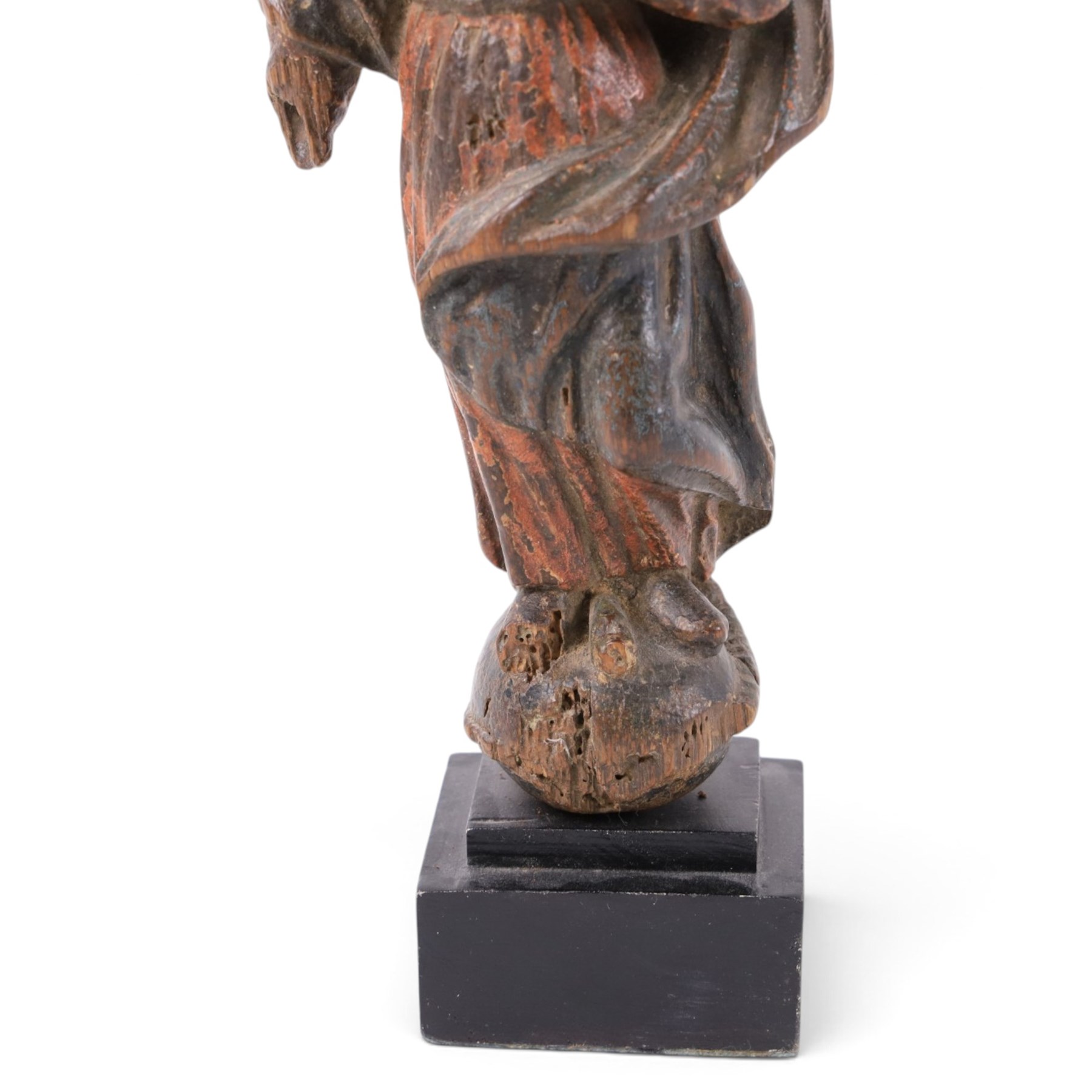 17th century, continental figure of saint, with painted polychrome detail, the figure adorned in robes, with hand on chest, upon a later wooden plinth, H31cm