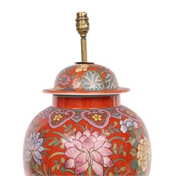 Table lamp of baluster form, decorated with ducks and lilies upon a red ground upon a circular wooden base, H64cm