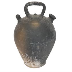 Four 20th century Spanish blackened earthenware botijo or cruche vessels, each of typical baluster form with central loop handle and opposing spout, impressed marks to handles, tallest example H31cm