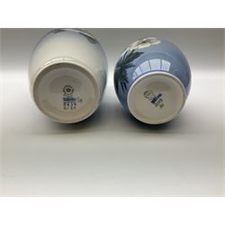 Two Royal Copenhagen vases, first example a vase of baluster form with apple blossom design on a pale blue ground, model no 2629 design no 2129 H27.5cm, second example a vase of ovoid form, with flower and butterfly decoration, model no 2667 design no 36 H17.5cm. 