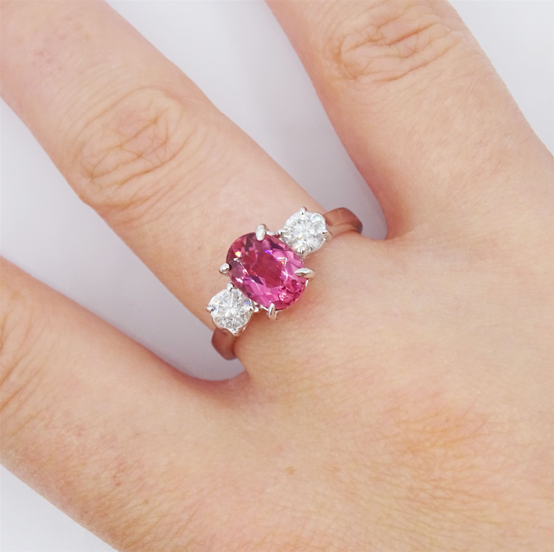 18ct white gold three stone oval cut pink tourmaline and round brilliant cut diamond ring, hallmarked, tourmaline approx 2.60 carat, total diamond weight approx 0.40 carat