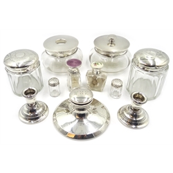  Two early 20th century glass scent bottles with silver and enamel stoppers, four dressing table jars with silver tops, pair of dwarf silver candlesticks, an inkstand and a pair of salt and peppers  